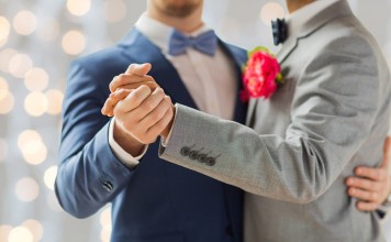 Catholic Archbishop Says Yes To Same-sex Partners At School Formals happy male gay couple holding hands and dancing