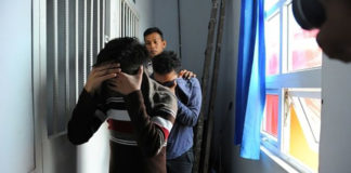 Indonesian Men Guilty of Gay Sex Sentenced to 85 Lashes A police officer escorts two men accused of having gay sex into a holding cell prior to their trial at sharia court in Banda Aceh AP