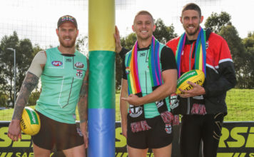 Environment Safe for Gay AFL Footballers to Come-Out According to Pride Match Stars Saints players Tim Membrey, Seb Ross and Tom hickey (L-R) with te custom rainbow goal wraps to be used at the pride match this weekend.(Supplied)