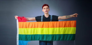 Rainbow Flag Torn To Raise Awareness of LGBTIQ+ Suicide Olly Alexander with the ripped rainbow flag (Youtube)