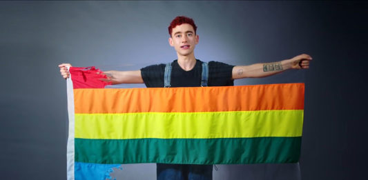 Olly Alexander with the ripped rainbow flag (Youtube)