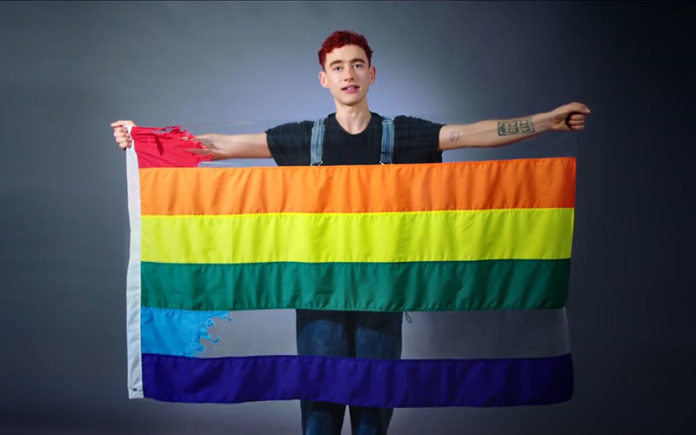 Olly Alexander with the ripped rainbow flag (Youtube)