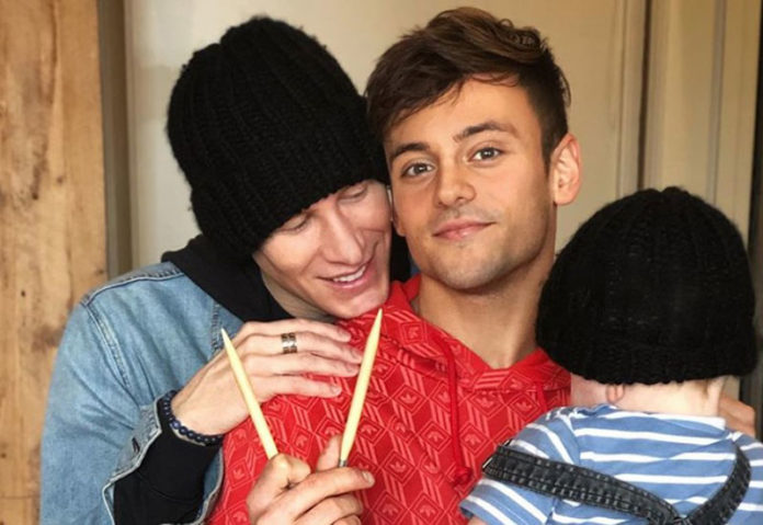 gay couple Dustin Lance Black and Tom Daley with their baby.