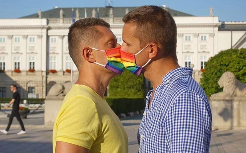 Gay couple hand out rainbow masks to combat covid