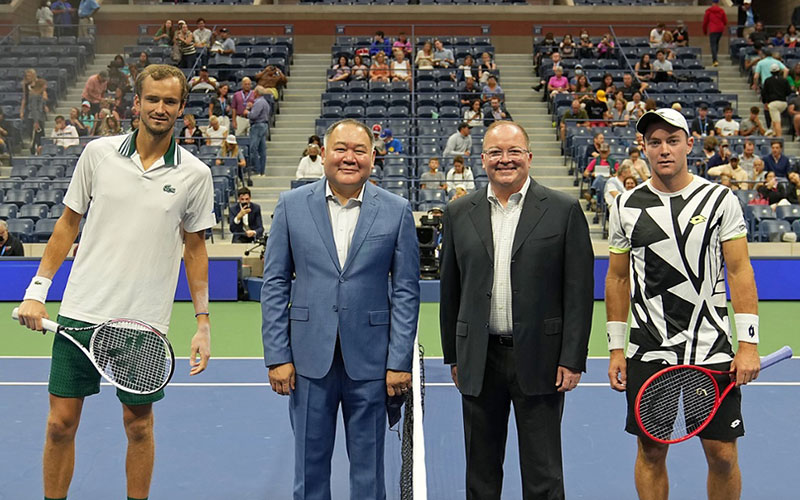 Dr. Bernard Camins from Mt. Sinai Hospital and the USTA Medical Advisory Group and his husband Brian Wigley participate in the coin toss for the men's singles match between Daniil Medvedev and Dominik Koepfer at the US Open on Pride Day