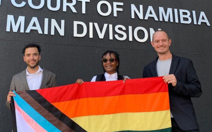 Guillermo Delgado (left) and Phillip Lühl (right) with their lawyer, Uno Katjipuka-Sibolile (centre). (Namibian Equal Rights Movement - INstagram)