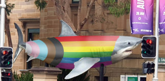 Jurassic Lounge Goes Rainbow With Pride Edition For Sydney Worldpride A Jurassic shark dressed in the progress flag outside the Australian Museum (Supplied)