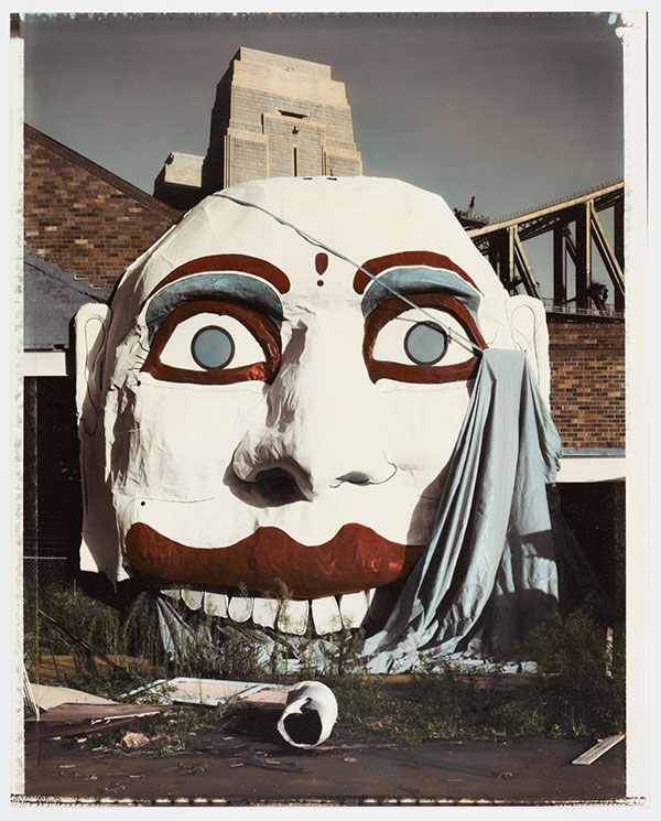 1990 - Face for Luna Park, Sydney, 1991 by Douglas Holleley Photographer Douglas Holleley hand-coloured this gelatin silver print. A photographic technique out of step with this relatively contemporary date giving the image an eerie appearance. (Supplied Shot Exhibition)