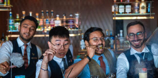 Grain Bar Reimagined: Sydney’s Theatrical Cocktail Playground Grain Bar bartenders (l-r) Sanjeev Sharma, Hai Ha Nguyen, Sarath Nair and Marco Rosati with the signature cocktails. (Supplied)
