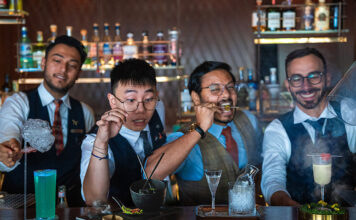 Grain Bar Reimagined: Sydney’s Theatrical Cocktail Playground Grain Bar bartenders (l-r) Sanjeev Sharma, Hai Ha Nguyen, Sarath Nair and Marco Rosati with the signature cocktails. (Supplied)