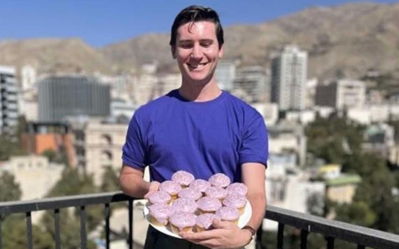 Second Secretary at the Australian Embassy in Tehran Tom Curran holds a plate of Wear it Purple Day cupcakes. (Instagram)